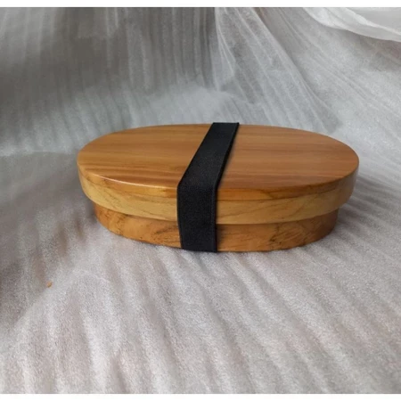 Child size oval food storage box made of wood